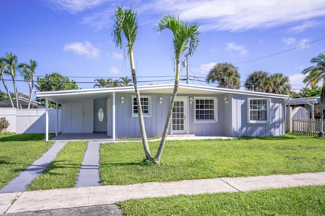 view of front facade with a front lawn and a carport