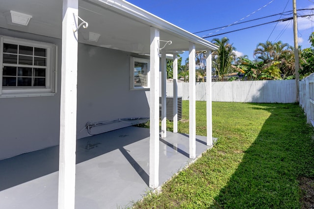 view of yard with central AC unit and a patio area