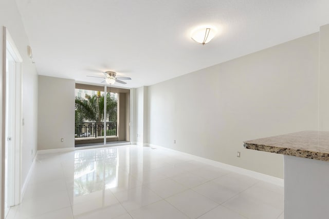 unfurnished room featuring ceiling fan and light tile patterned floors