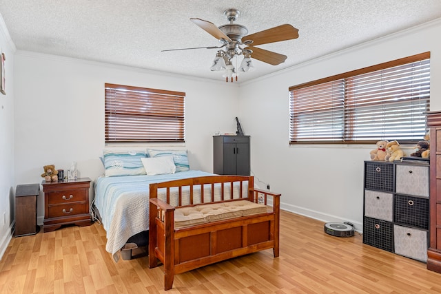 bedroom with a textured ceiling, light hardwood / wood-style floors, ornamental molding, and ceiling fan