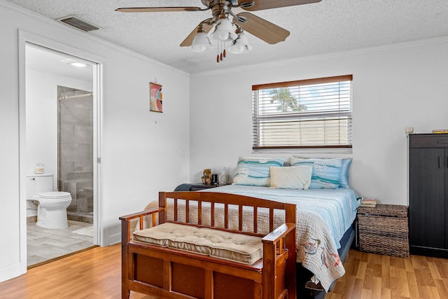 bedroom featuring wood-type flooring, a textured ceiling, connected bathroom, ornamental molding, and ceiling fan