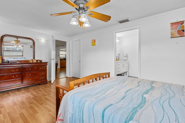 bedroom featuring ceiling fan, ornamental molding, a textured ceiling, light wood-type flooring, and ensuite bathroom