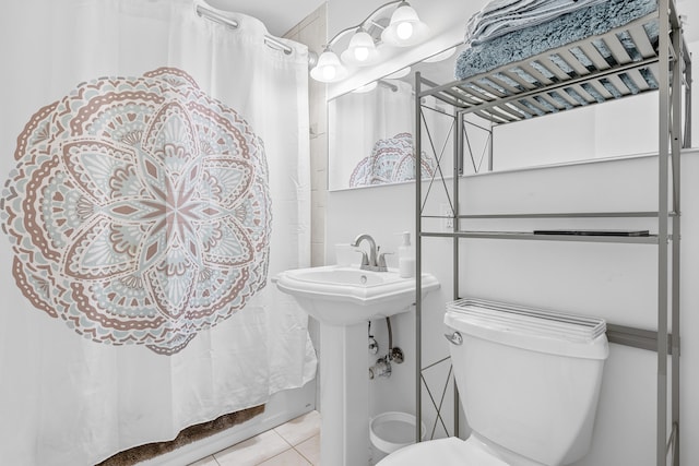 bathroom with tile patterned flooring, curtained shower, and toilet