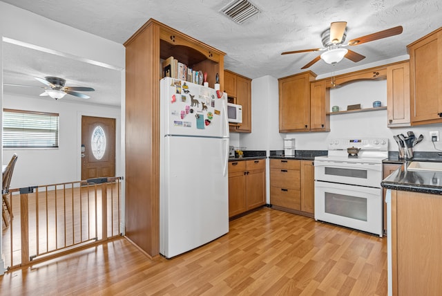 kitchen with white appliances, ceiling fan, light hardwood / wood-style floors, and a textured ceiling