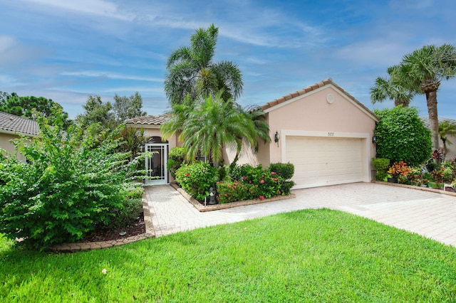 view of front of property featuring a garage and a front yard