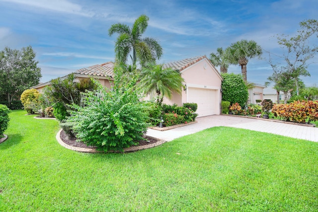 view of front of property featuring a garage and a front yard