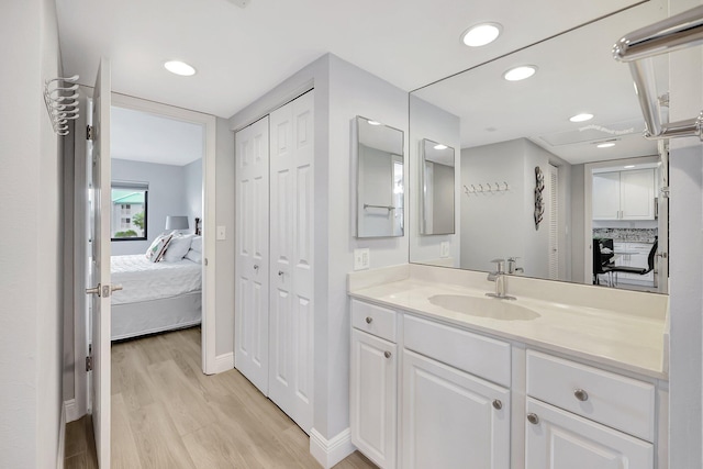 bathroom with vanity and hardwood / wood-style flooring