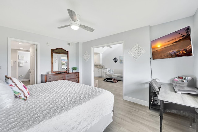 bedroom with connected bathroom, ceiling fan, and light wood-type flooring