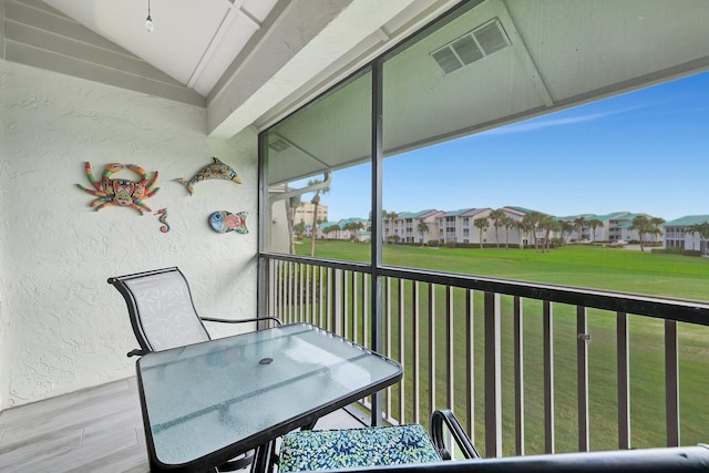 unfurnished sunroom featuring vaulted ceiling