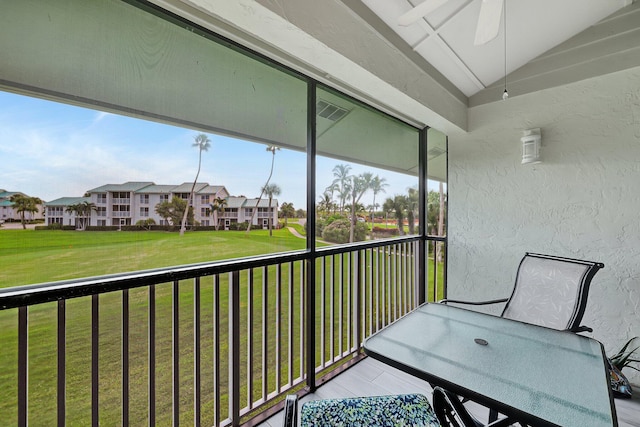 unfurnished sunroom featuring lofted ceiling and ceiling fan