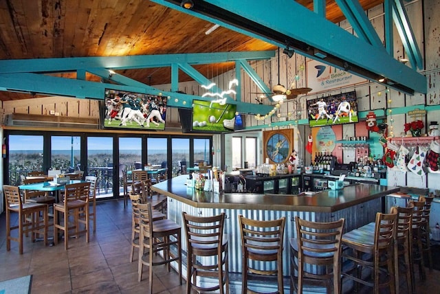 bar with high vaulted ceiling, wooden ceiling, and beam ceiling