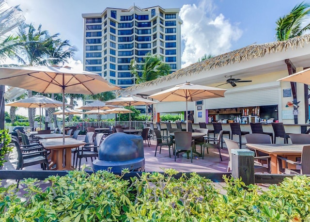 view of patio / terrace with ceiling fan and an outdoor bar