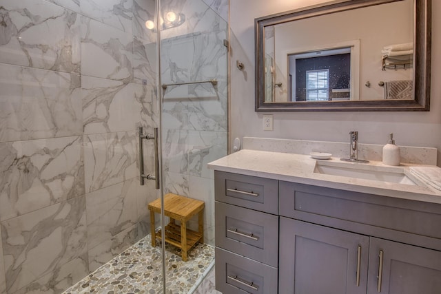 bathroom with a marble finish shower and vanity
