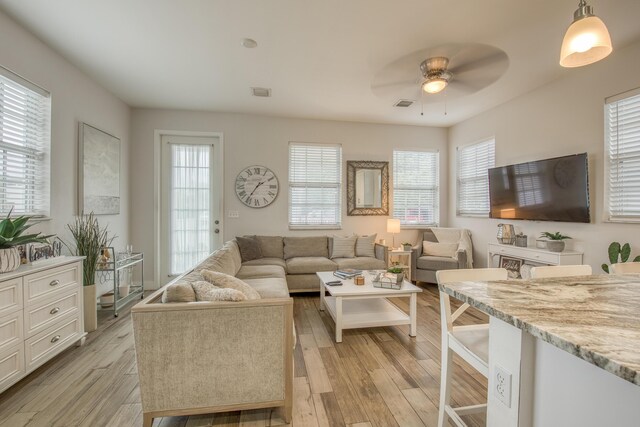 living room featuring ceiling fan and light wood-type flooring