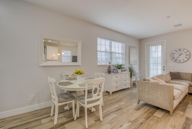 dining space featuring light wood-type flooring