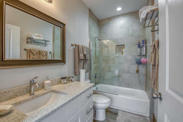 bathroom featuring toilet, tub / shower combination, recessed lighting, vanity, and wood finished floors