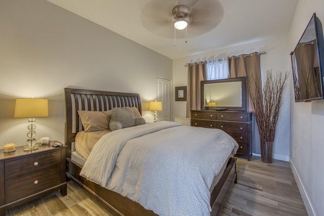 bedroom featuring baseboards, a ceiling fan, and wood finished floors