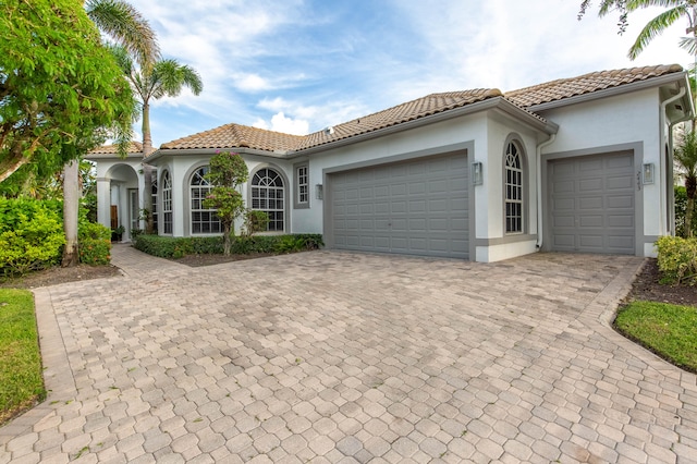 mediterranean / spanish-style house featuring a garage