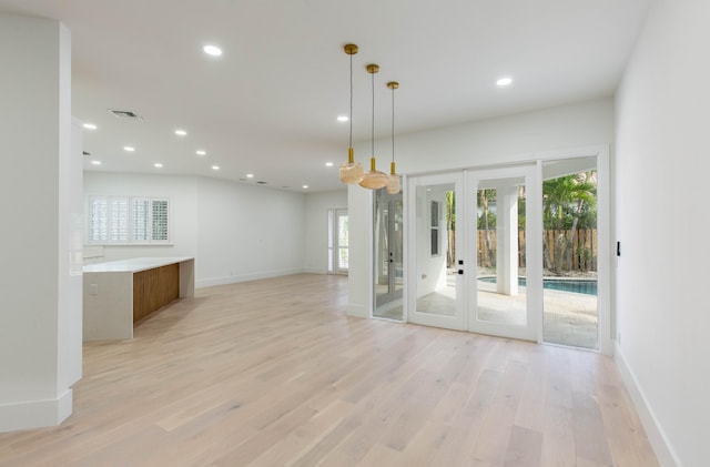 interior space with french doors and light hardwood / wood-style flooring