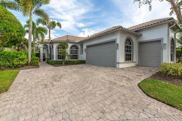 mediterranean / spanish-style house with a garage