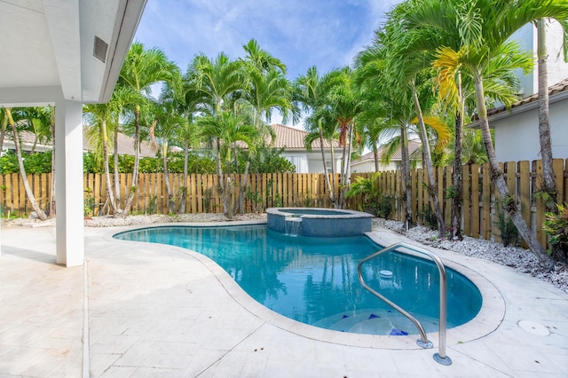 view of pool with an in ground hot tub and a patio area