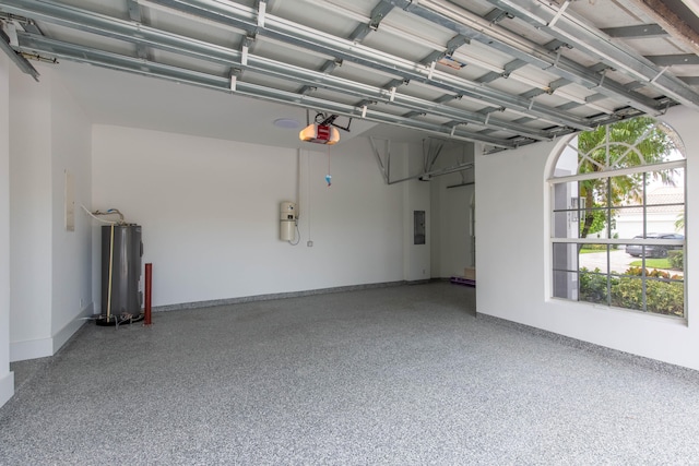 garage featuring electric panel, a garage door opener, and water heater