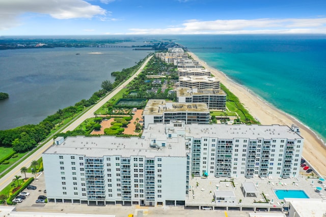 aerial view with a water view and a beach view