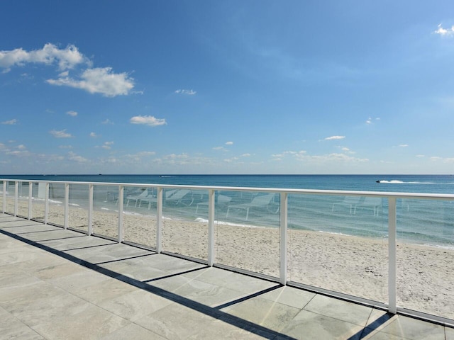 balcony with a view of the beach and a water view