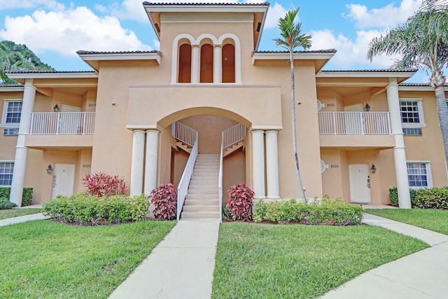 8010 Carnoustie Pl Unit 4022, Port Saint Lucie, FL 34986 - view of front of home featuring stucco siding, a front lawn, and stairway