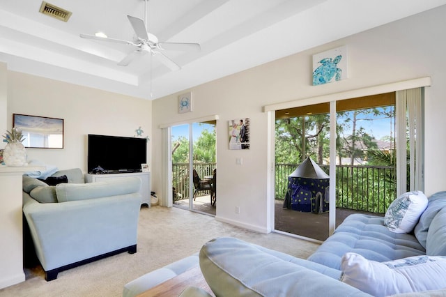 8010 Carnoustie Pl Unit 4022, Port Saint Lucie, FL 34986 - living area with plenty of natural light, light colored carpet, a ceiling fan, and a raised ceiling