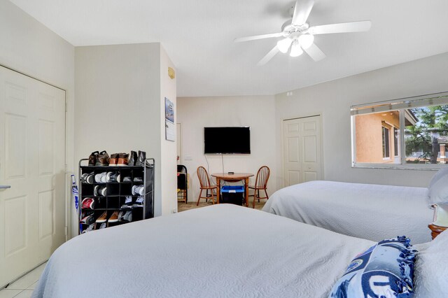 tiled bedroom with ceiling fan