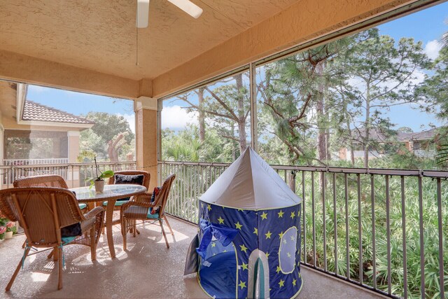 sunroom featuring ceiling fan