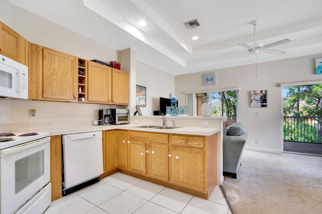 kitchen with sink, kitchen peninsula, light colored carpet, white appliances, and ceiling fan