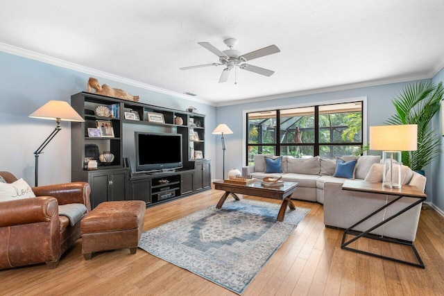 living room with ceiling fan, ornamental molding, and wood-type flooring