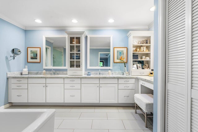 bathroom featuring crown molding, vanity, a bathing tub, and tile patterned floors