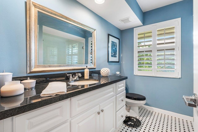 bathroom featuring vanity, tile patterned flooring, and toilet