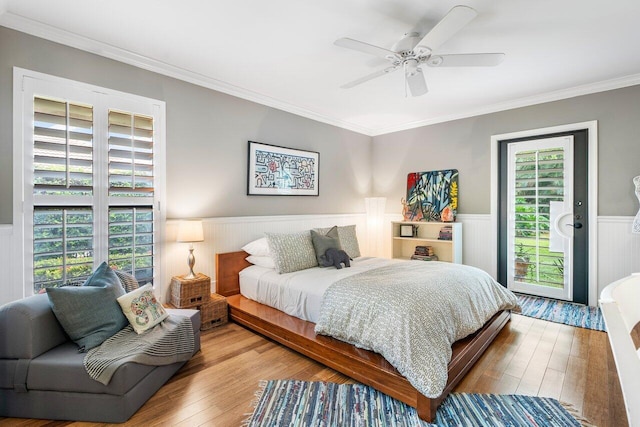 bedroom with multiple windows, light wood-type flooring, ceiling fan, and access to exterior