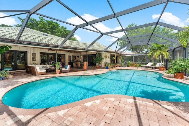 view of pool with an outdoor hangout area, a lanai, ceiling fan, and a patio area