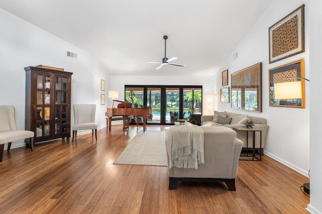 living room featuring lofted ceiling, ceiling fan, and hardwood / wood-style floors