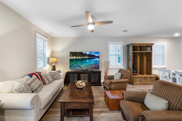 living room featuring ceiling fan and hardwood / wood-style floors