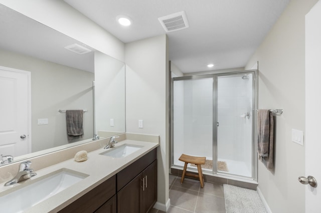 bathroom featuring tile patterned flooring, vanity, and a shower with door