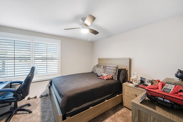 carpeted bedroom featuring a textured ceiling and ceiling fan