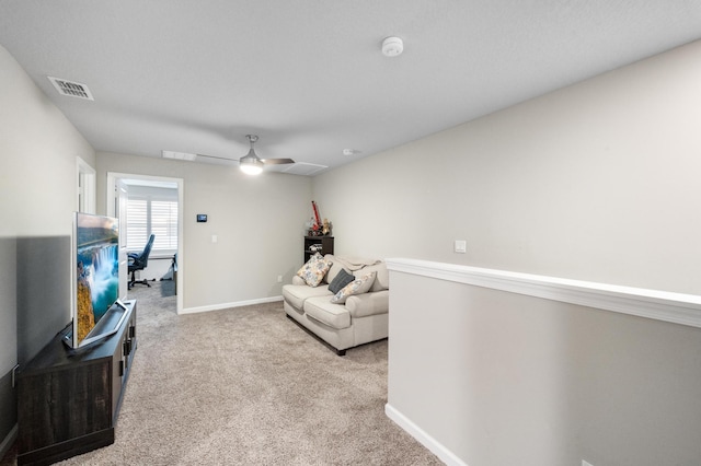 sitting room featuring ceiling fan and light colored carpet