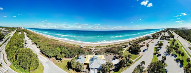 drone / aerial view with a water view and a beach view