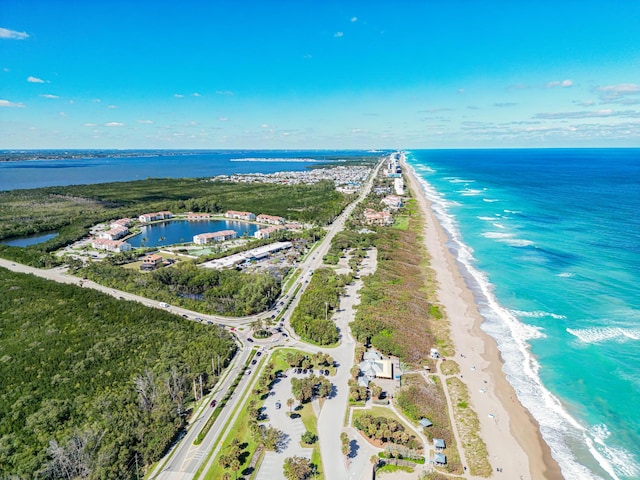 aerial view with a water view and a view of the beach