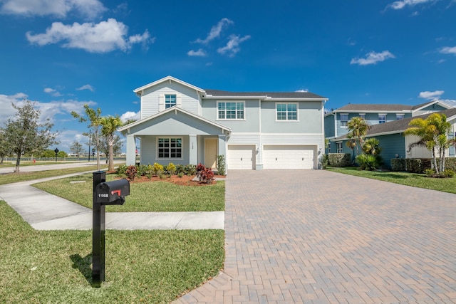 view of front of house featuring a garage and a front lawn