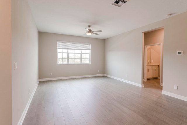 spare room with ceiling fan and light hardwood / wood-style floors