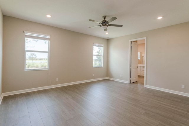 empty room with ceiling fan and light wood-type flooring