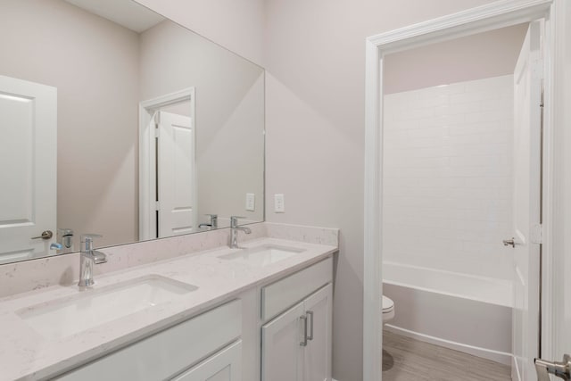 full bathroom with wood-type flooring, vanity, toilet, and shower / bathing tub combination