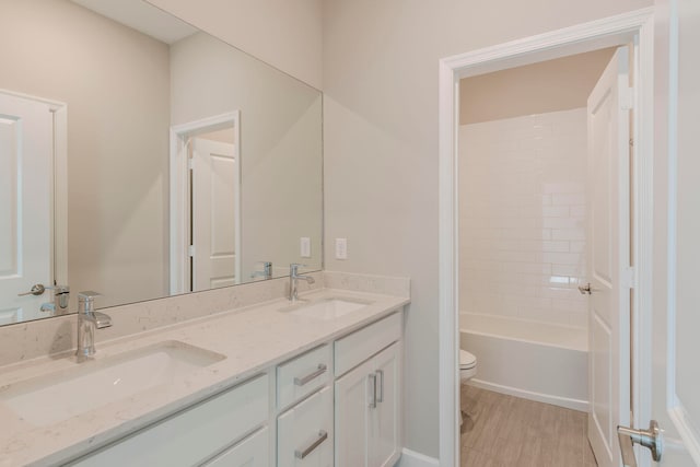 full bathroom featuring vanity, toilet, and tiled shower / bath